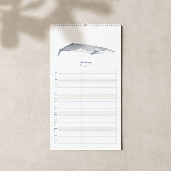 January page of the 2025 family planner calendar with fin whale illustration.