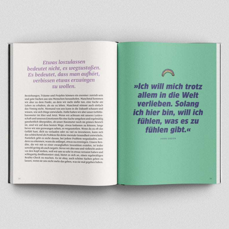 Pages of the self-improvement book 'Das große Buch der guten Gedanken' featuring German text on letting go and a quote about embracing life by John Green.