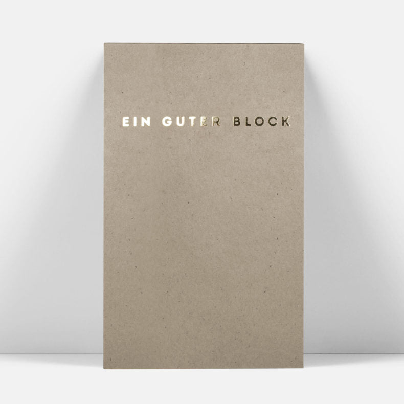 Front view of 'Ein Guter Block' notepad made from recycled paper with minimalistic design, displayed against a white background.